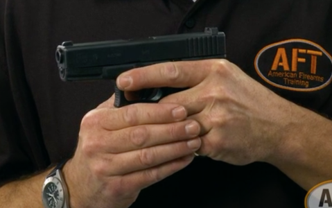 American Firearms Training instructor holding a handgun safely